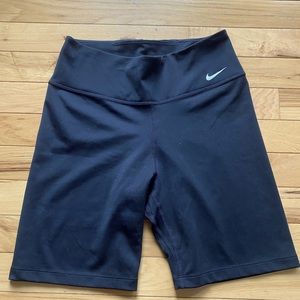 Higher waisted black spandex, longer pant legs. Comes from popular brand Nike.